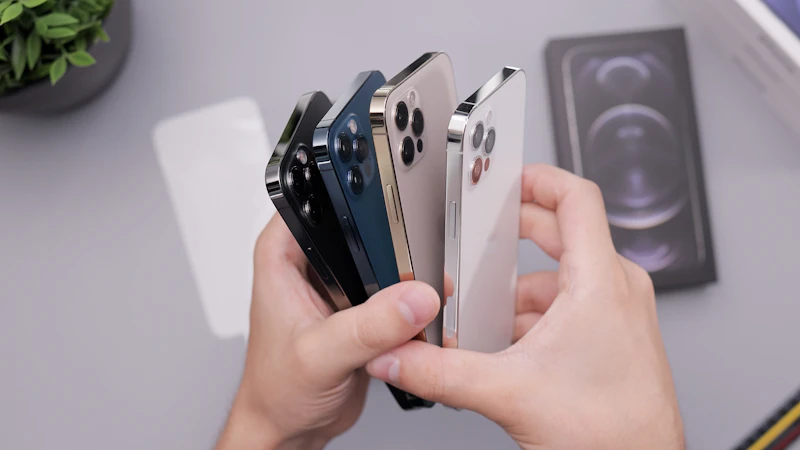 Hands holding a stack of repaired smartphones